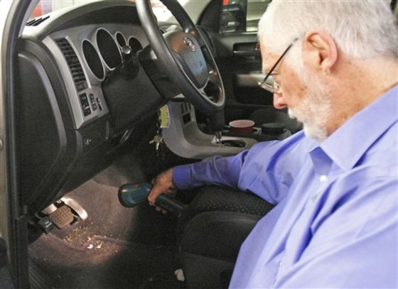 Earl Stewart, owner of Earl Stewart Toyota, in North Palm Beach, Fla., gestures to the accelerator of a recalled Toyota.